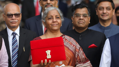 India's Finance Minister Nirmala Sitharaman holds up a folder with the Government of India’s logo