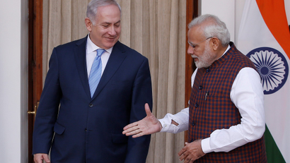 India's Prime Minister Modi extends his hand for a handshake with his Israeli counterpart Netanyahu during a photo opportunity ahead of their meeting at Hyderabad House in New Delhi