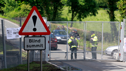 Police officers guard the security fence surrounding the G8 Summit at Lough Erne in Enniskillen, Northern Ireland June 17, 2013.