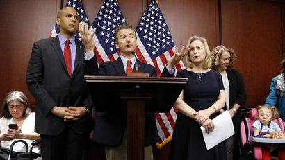 U.S. Senator Cory Booker (D-NJ) (from 2nd L), Senator Rand Paul (R-KY), and Senator Kirsten Gillibrand (D-NY) hold a news conference, to introduce legislation that would prevent the federal government from prosecuting medical marijuana users in states where it is legal, at the U.S. Capitol in Washington, March 10, 2015. Also pictured are medical marijuana patients Sandy Faiola (L) from New Jersey and Morgan Jones (bottom R), a 4-year-old Druvet syndrome sufferer from New York.