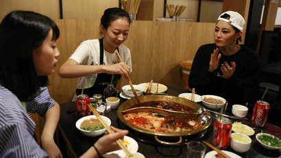 Chinese model Sun Yichao (R) and her juniors Jiang Ruiqi (L) and Li Yuzu from the same modelling agency have a hotpot dinner at a restaurant after the Melody Cashmere show during the Mercedes-Benz China Fashion Week at the Beijing Hotel banquet hall venue in Beijing, China, 29 March 2017. One of China's most promising up and coming fashion model, the 23-year-old Sun Yichao is a striking figure on the runway. At 1.79 metres tall, the svelte model with beautiful chiseled features is high in demand domestically and abroad, having walked the catwalks of Paris, Milan and New York's fashion weeks for major brands like Christian Dior and Chanel. She was also one of the recipients of the 'China Top Ten Professional Fashion Model Award' in 2016. EPA/HOW HWEE YOUNG PLEASE REFER TO ADVISORY NOTICE (epa05887201) FOR FULL PACKAGE TEXT