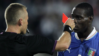 Italy's Mario Balotelli is given a red card.