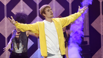 Justin Bieber holding up his arms at a performance.