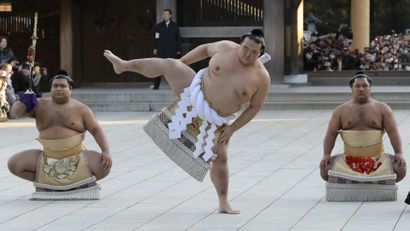 In this Friday, Jan. 27, 2017 photo, newly-promoted sumo grand champion Kisenosato performs his ring entry form at the Meiji Shrine in Tokyo. Kisenosato is the first Japanese wrestler to earn the coveted rank of "yokozuna," grand champion, since 1998. Accompanying Kisenosato are sward-holder Takayasu, left, and dew-sweeper Shohozan, right. (AP Photo/Eugene Hoshiko, File)