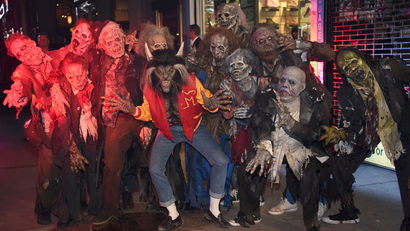 Heidi Klum, center, dressed as a werewolf from Michael Jackson's "Thriller" video, attends her 18th Annual Halloween Party at Moxy Times Square on Tuesday, Oct. 31, 2017, in New York. (Photo by Evan Agostini/Invision/AP)