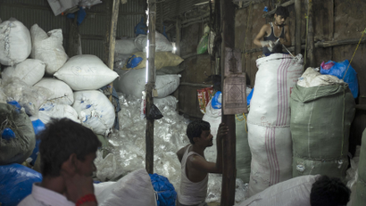 Inside a recycling factory in India, workers Sort through plastic waste