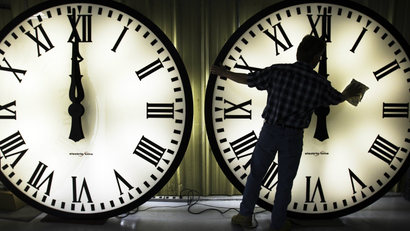 A man cleaning clocks