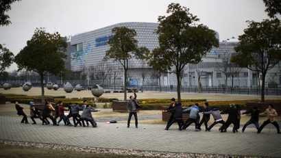Local residents play tug-of-war as they pull a rope at a park in Shanghai March 2, 2014.