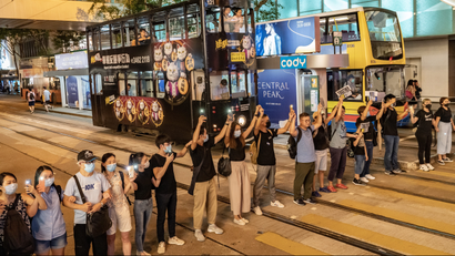 Proteters form a A human chain in front of bus and tram traffic in Hong Kong