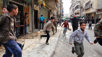 People run upon hearing a nearby plane bombing during a protest against Syrian President al-Assad in Aleppo