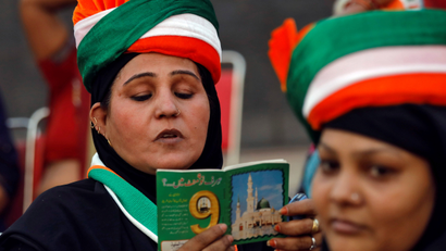 Muslim woman reads Koranic supplication as she attends an election campaign rally addressed by India's main opposition Congress party President Rahul Gandhi in New Delhi
