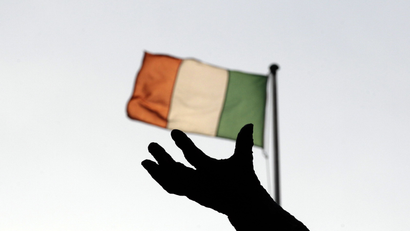 Ireland's national flag flies above a statue on O'Connell Street in Dublin December 5, 2011. Ireland's government on Monday unveils what it hopes will be the toughest budget of its five-year term, but as it tries to keep the public onside economists are warning that a global downturn means the worst may be yet to come. REUTERS/Cathal McNaughton (IRELAND - Tags: POLITICS BUSINESS SOCIETY)