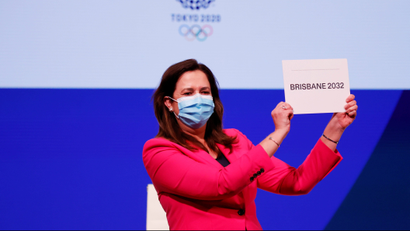 Premier of Queensland Annastacia Palaszczuk holds a sign that reads "Brisbane 2023."