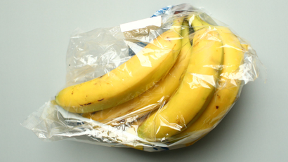 Bananas, wrapped in a plastic as bought in a supermarket