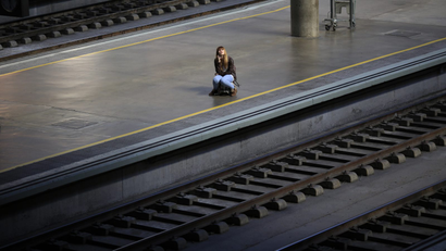Woman alone on a train platform.