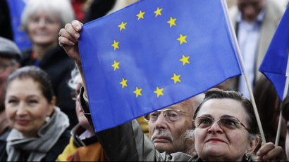 A woman holds up a EU flag during the speech of German Chancellor Angela Merkel at an election rally in Berlin.