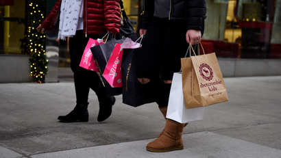 Shoppers carry bags from a number of stores including Abercrombie &amp; Fitch and Victoria's Secret along Fifth Avenue in the Manhattan borough of New York