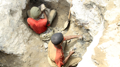 Two artisanal miners work at a cobalt mine-pit in the Democratic Republic of Congo.
