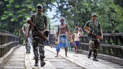Indian security personnel patrol on a road ahead of the publication of the final draft of the National Register of Citizens (NRC) at Kachari Para village, in Hojai district, northeastern state of Assam, India