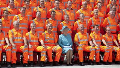 Queen Elizabeth poses for a photo with British construction workers