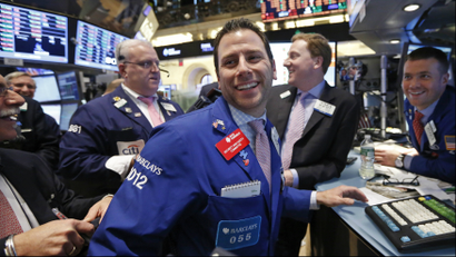 A trader at the New York Stock Exchange smiling