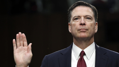Former FBI director James Comey is sworn in during a Senate Intelligence Committee hearing on Capitol Hill