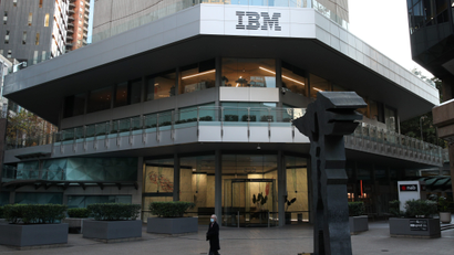 A man wearing a protective mask walks past an office building with IBM logo amidst the easing of the coronavirus disease (COVID-19) restrictions in the Central Business District of Sydney, Australia.