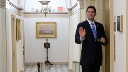 Rep. Paul Ryan, R-Wis., gestures to media as he stands ready to board the elevator that serves the office of House Speaker John Boehner of Ohio, on Capitol Hill, Tuesday, Oct. 15, 2013, in Washington. The partial government shutdown is in its third week and less than two days before the Treasury Department says it will be unable to borrow and will rely on a cash cushion to pay the country's bills.
