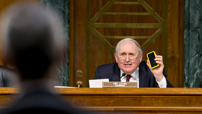 Senate Homeland Security and Governmental Affairs Permanent subcommittee on Investigations Chairman Sen. Carl Levin, D-Mich., holds up his own Apple iPhone, on Capitol Hill in Washington, Tuesday, May 21, 2013, as he presses Apple CEO Tim Cook, left, for answers about how Apple, the world's most valuable company, and based in Cupertino, Calif., diverts a billion dollars to an Irish subsidiary as a tax strategy, according to a report issued this week by the subcommittee.
