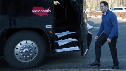 Republican presidential candidate Sen. Marco Rubio, R-Fla., smiles as he gets on his bus as he leaves a campaign stop, Sunday, Jan. 3, 2016, in Atkinson, N.H.