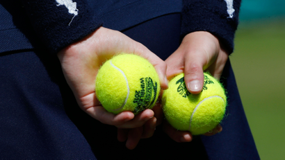 A ball girl holds tennis balls at the Wimbledon Tennis Championships in London