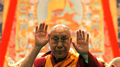 Tibet's exiled spiritual leader the Dalai Lama gestures as he arrives to give a public religious lecture to the faithful in Strasbourg, France, September 17, 2016.