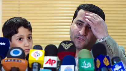 Shahram Amiri speaking next to his son after his July 2010 return to Iran.