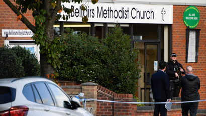 A police officer guards the scene outside a church where a politician was stabbed.