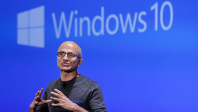 FILE - In this Jan. 21, 2015 file photo, Microsoft CEO Satya Nadella speaks at an event demonstrating the new features of Windows 10 at the company's headquarters in Redmond, Wash. Microsoft reports quarterly financial results on Monday, Jan. 26, 2015. (AP Photo/Elaine Thompson, File)