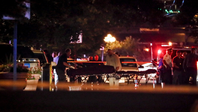 Stretchers and ambulances are pictured in the night carrying away bodies after the Dayton, Ohio mass shooting