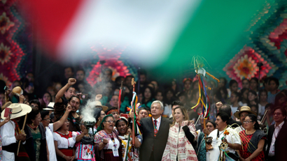 Mexico's newly sworn-in President Andres Manuel Lopez Obrador holds up a chieftain's staff during a traditional indigenous ceremony at the Zocalo, in Mexico City,