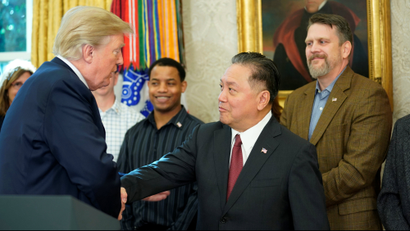 U.S. President Donald Trump shakes hands with Hock E. Tan, CEO of Broadcom as Trump delivered remarks about the situation of the jobs market in the Oval Office of the White House in Washington, U.S. November 2, 2017.