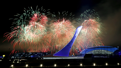 Fireworks burst over the Olympic cauldron during the closing ceremony of the 2014 Winter Olympics, Sunday, Feb. 23, 2014, in Sochi, Russia. (AP Photo/Julio Cortez)