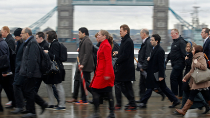 Rush hour workers pass Tower Bridge in London