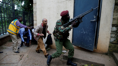 A member of security forces keeps guard as people are evacuated at the scene where explosions and gunshots were heard at the Dusit hotel compound, in Nairobi, Kenya January 15, 2019.