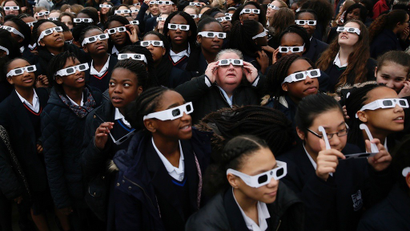 Kids in London watch eclipse.