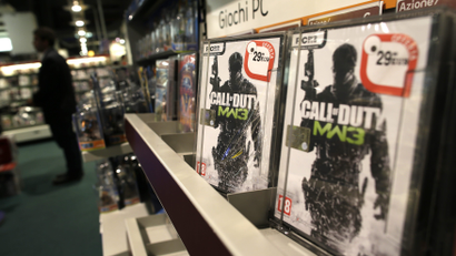 Copies of video game Call of Duty line a store shelf.