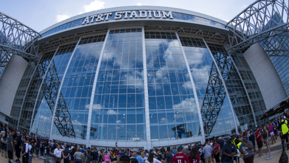 An entrance to AT&T stadium with fans milling about.