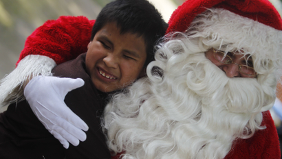 Santa Claus hugging child