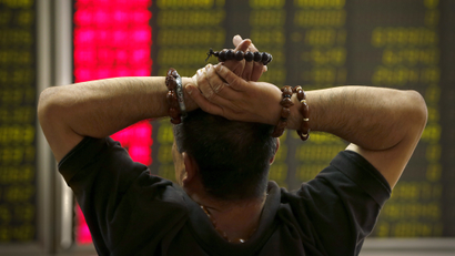 A Chinese investor monitors stock prices at a brokerage house in Beijing, Monday, Aug. 24, 2015. Stocks tumbled across Asia on Monday as investors shaken by the sell-off last week on Wall Street unloaded shares in practically every sector.