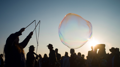 A reveller creates bubbles as she celebrates the summer solstice on Salisbury Plain in southern England June 21, 2014. Stonehenge is a celebrated venue of festivities during the summer solstice - the longest day of the year in the northern hemisphere - and it attracts thousands of revellers, spiritualists and tourists. Druids, a pagan religious order dating back to Celtic Britain, believe Stonehenge was a centre of spiritualism more than 2,000 years ago.