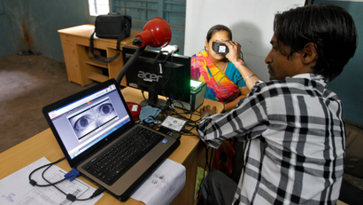 A woman goes through the process of eye scanning for Unique Identification database system in the outskirts of Ahmedabad