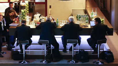 Participants sit at a bar during the annual meeting of the World Economic Forum (WEF) in Davos
