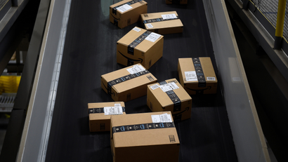 Photo of Amazon Prime packages leaving a conveyor belt at an Amazon facility.